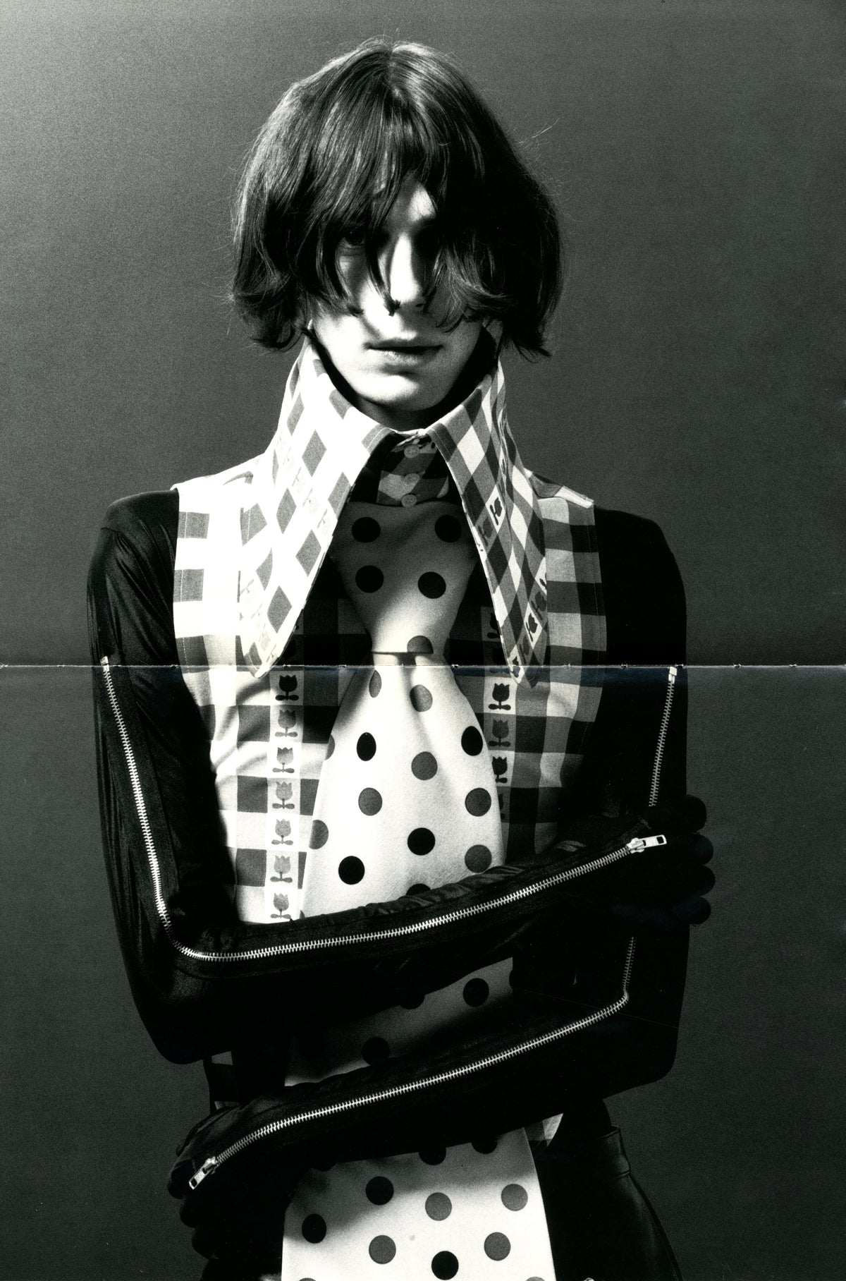 Fashion photograph from A Magazine N°A: model with a bob haircut in a polka-dot high collar and black gloss sleeves.