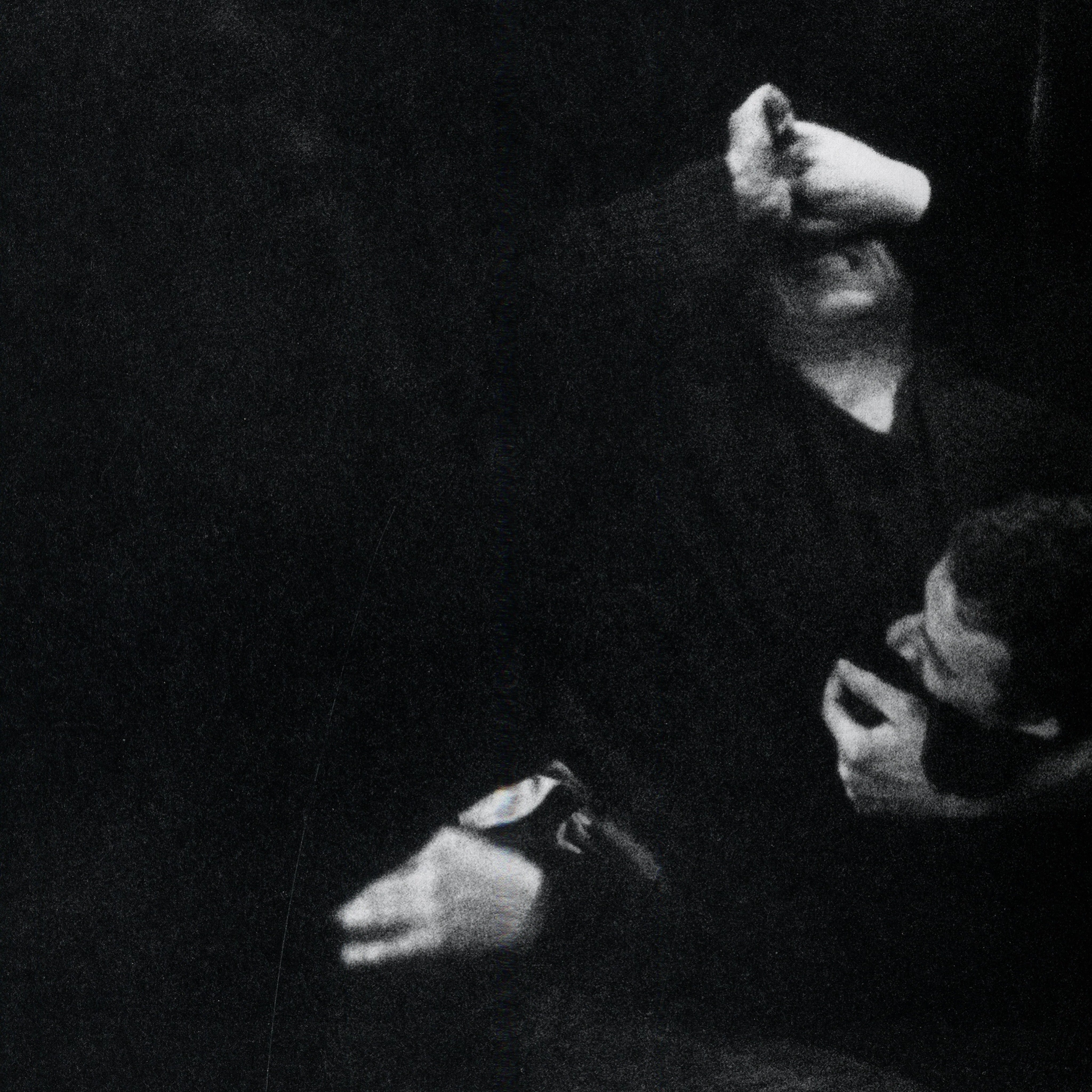 Black and white portrait of a person emerging from darkness. intermission books.