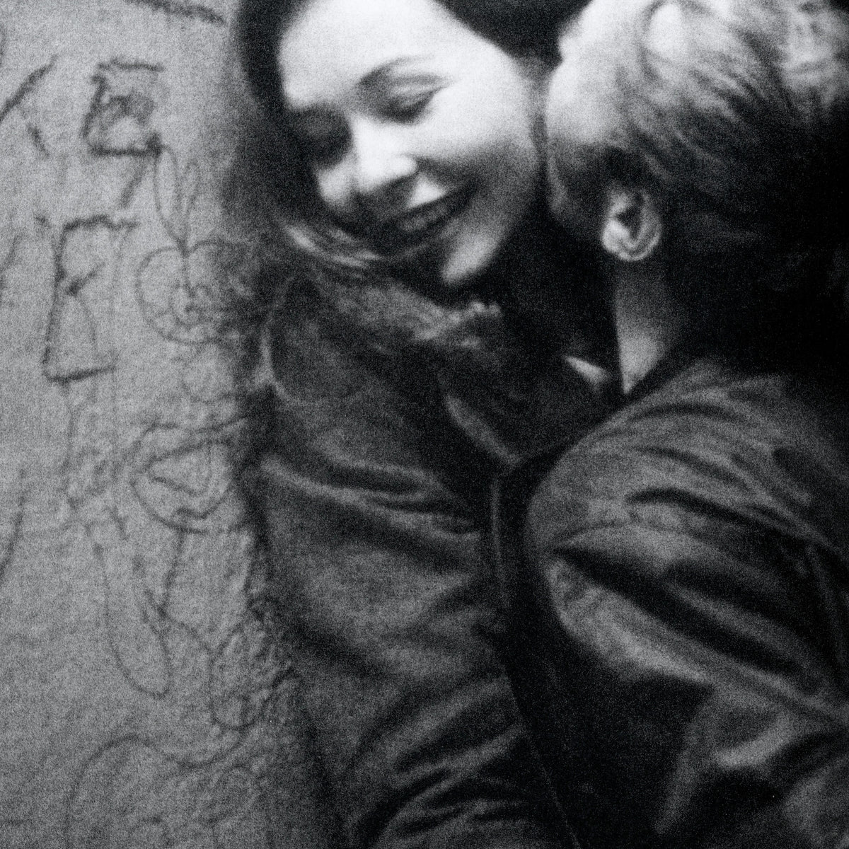 Black and white photograph of two people embracing. intermission books.