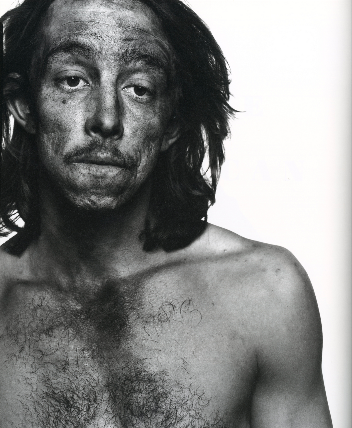 Richard Avedon In the American West interior oil worker portrait bare chest intense gaze white background interior 2 intermission books.