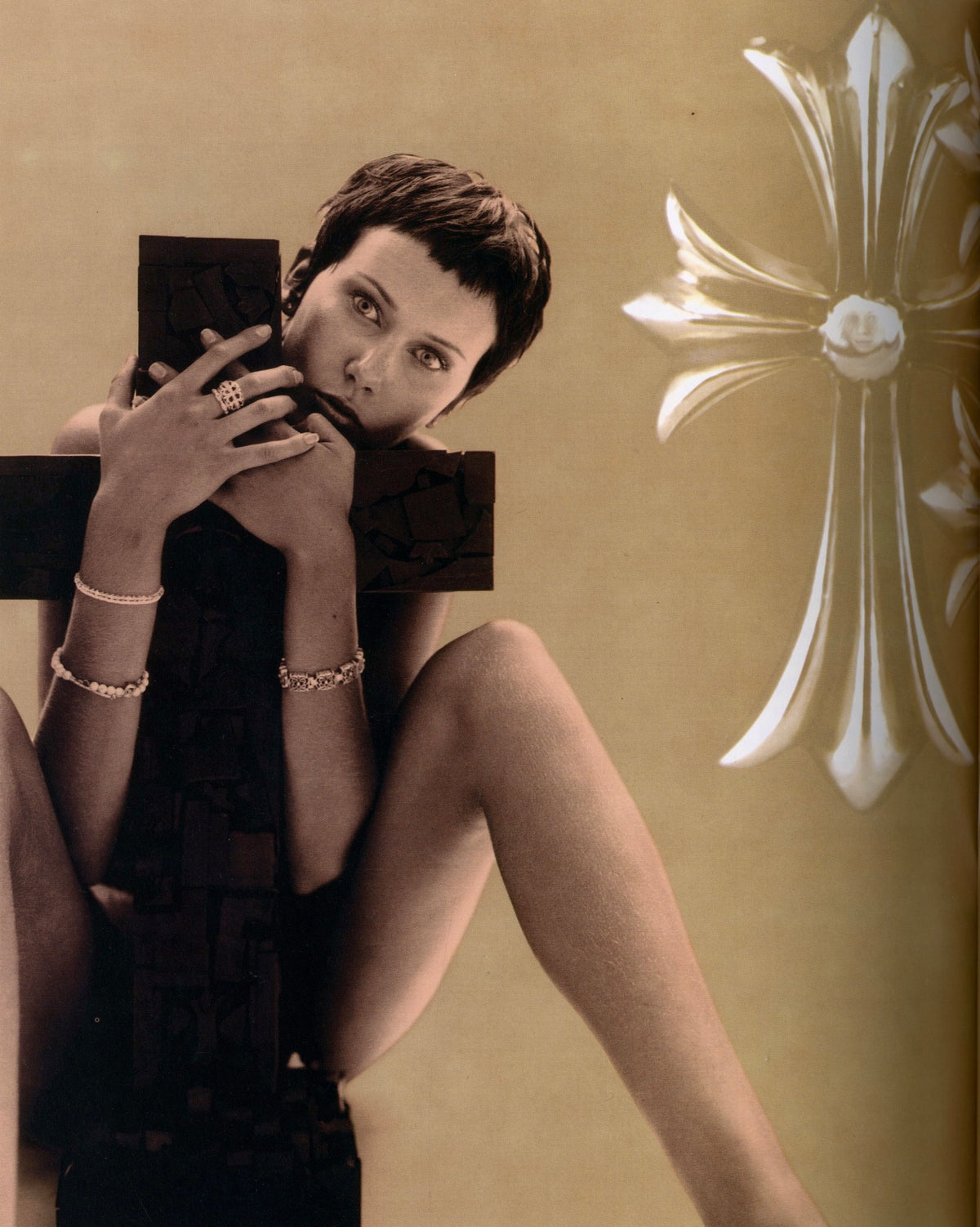 Woman posed with a large black cross beside the Chrome Hearts dagger emblem, Chrome Hearts Magazine Vol. 1.
