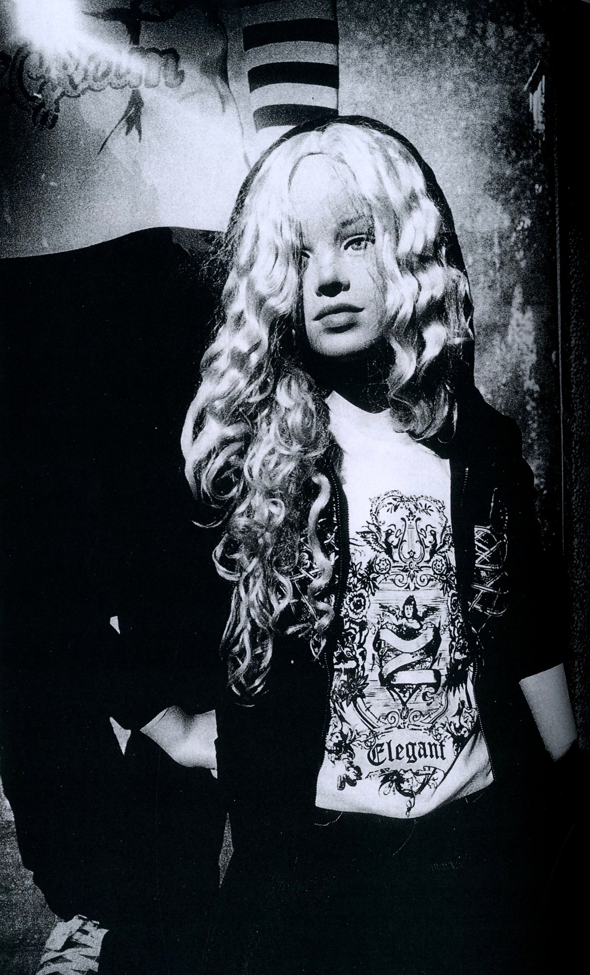 Mannequin with long curly blonde wig and graphic T-shirt, black-and-white plate from Plastic Love.