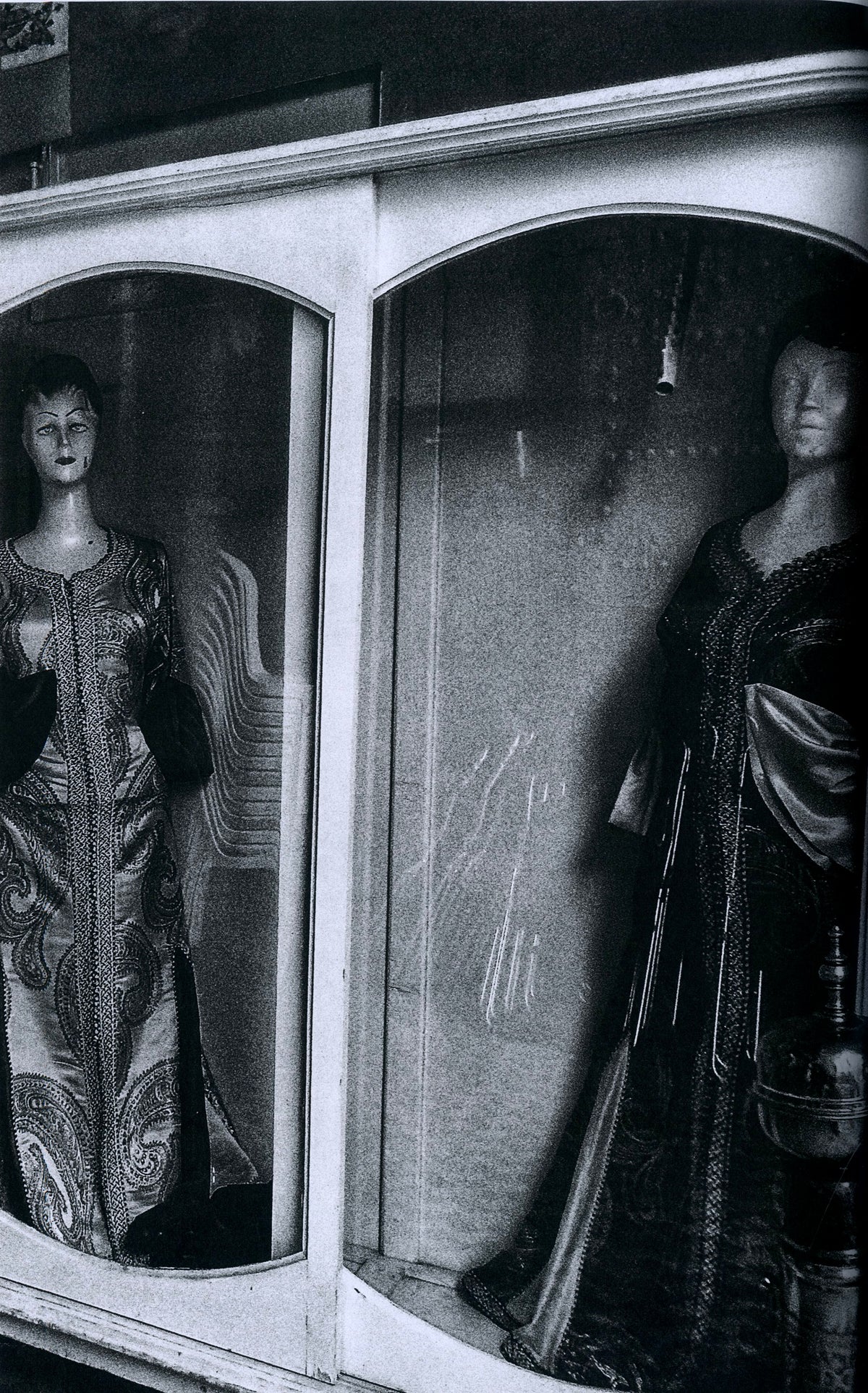 Dressed mannequins in arched shop windows, black-and-white plate by Daido Moriyama.