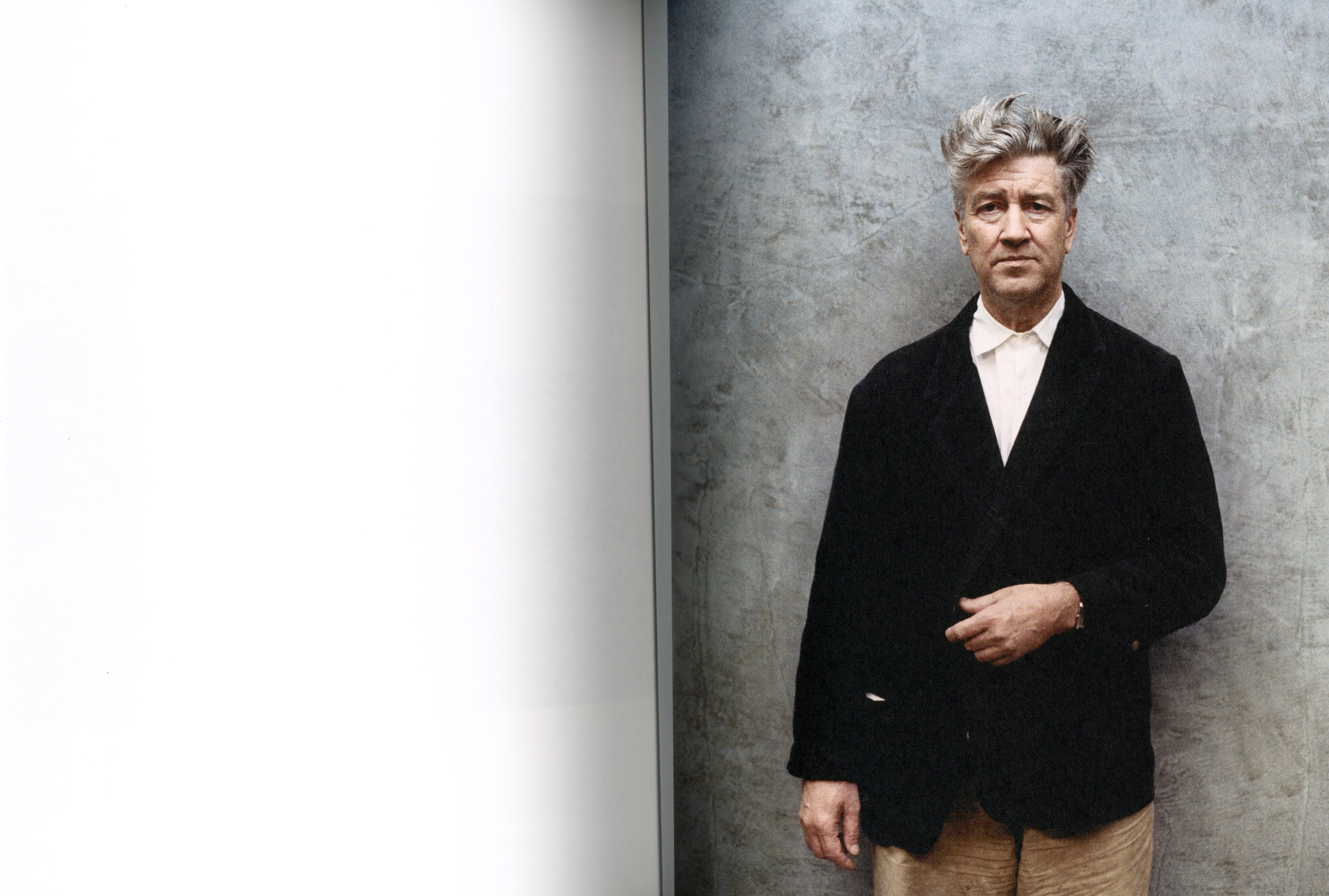 David Lynch Chaos Theory interior David Lynch portrait standing black suit white wall interior 6 intermission books.