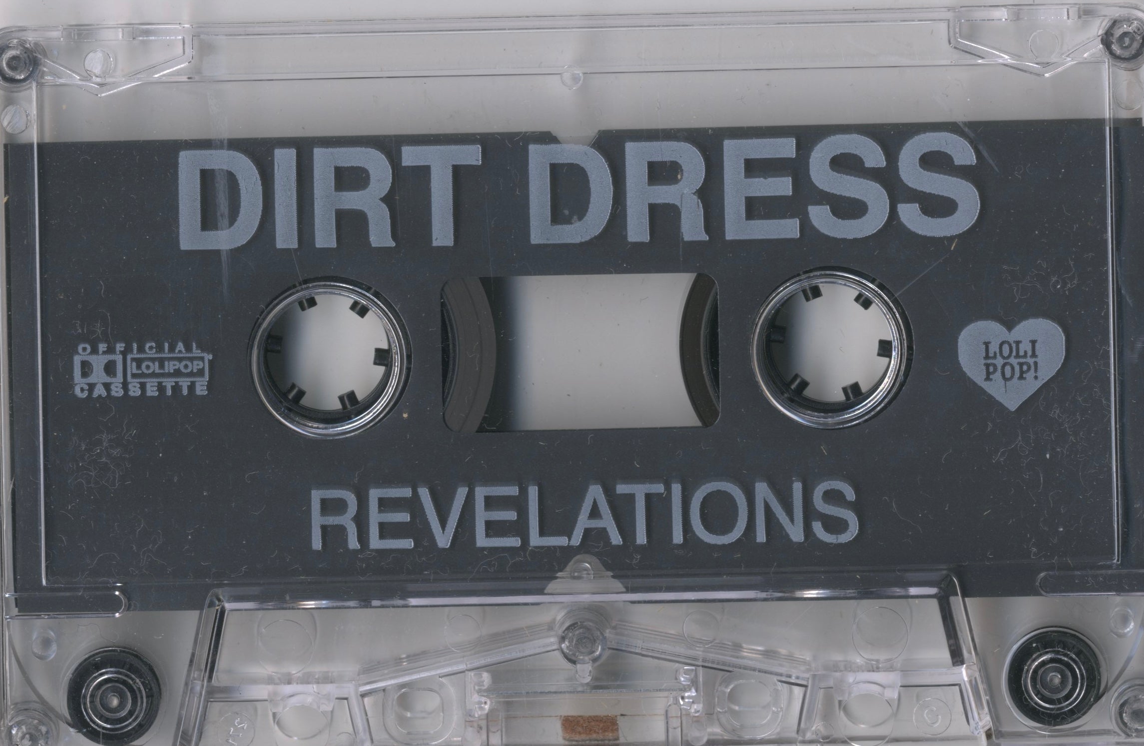 Cassette insert from Dirt Dress’s Revelations — shadowed lyrics and textures from the Los Angeles underground.
