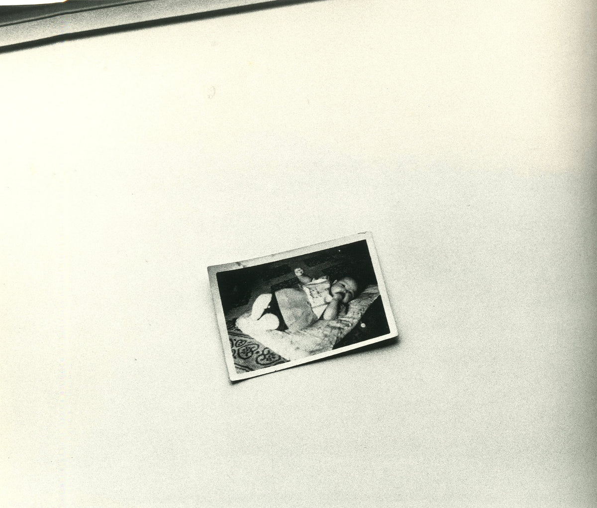 Photograph from Hysteric No. 5: a small snapshot print lying askew on a bare white surface.