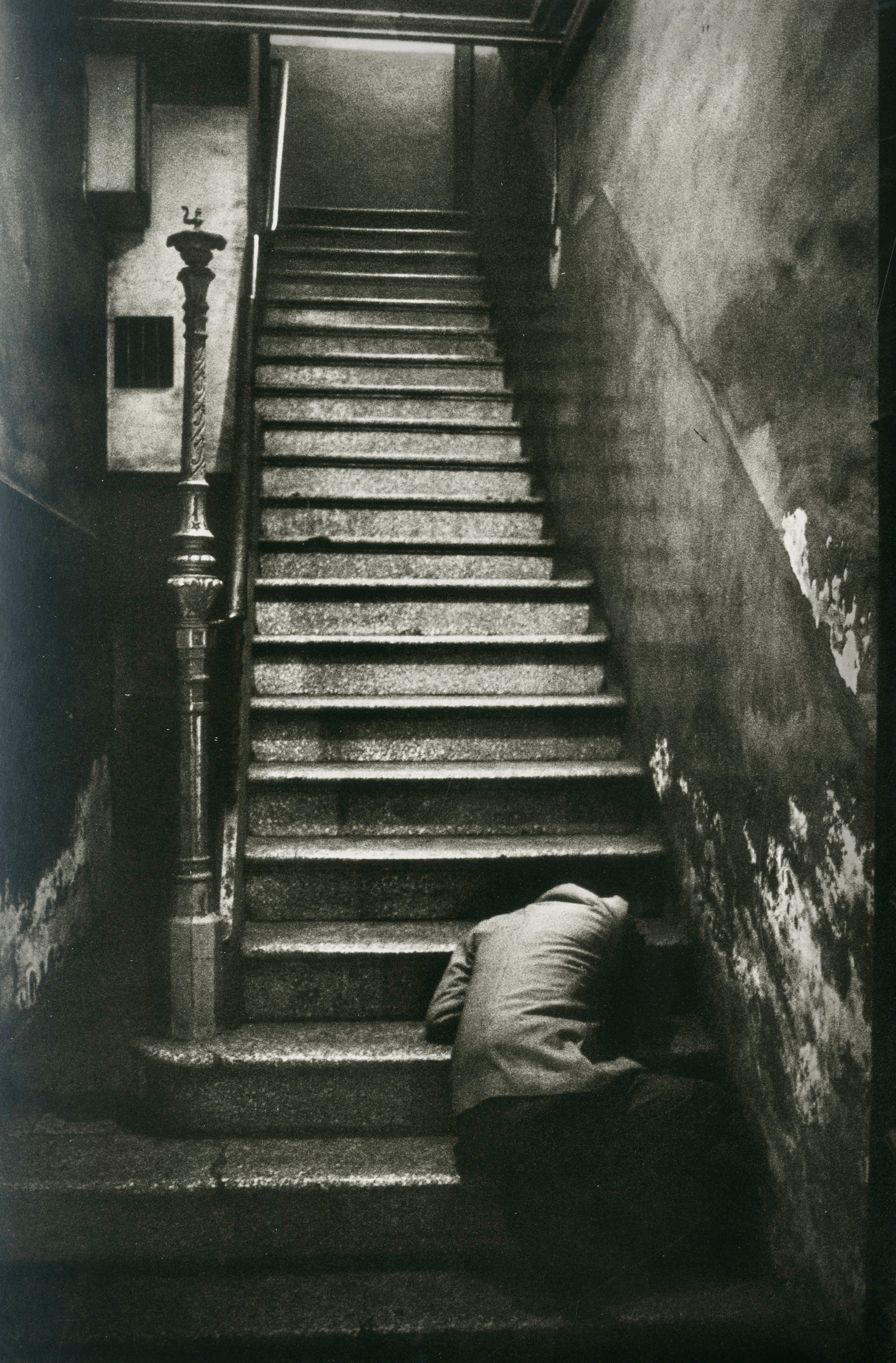 Interior spread from Koudelka’s “Exiles” showing stark black-and-white imagery capturing themes of solitude and displacement.
