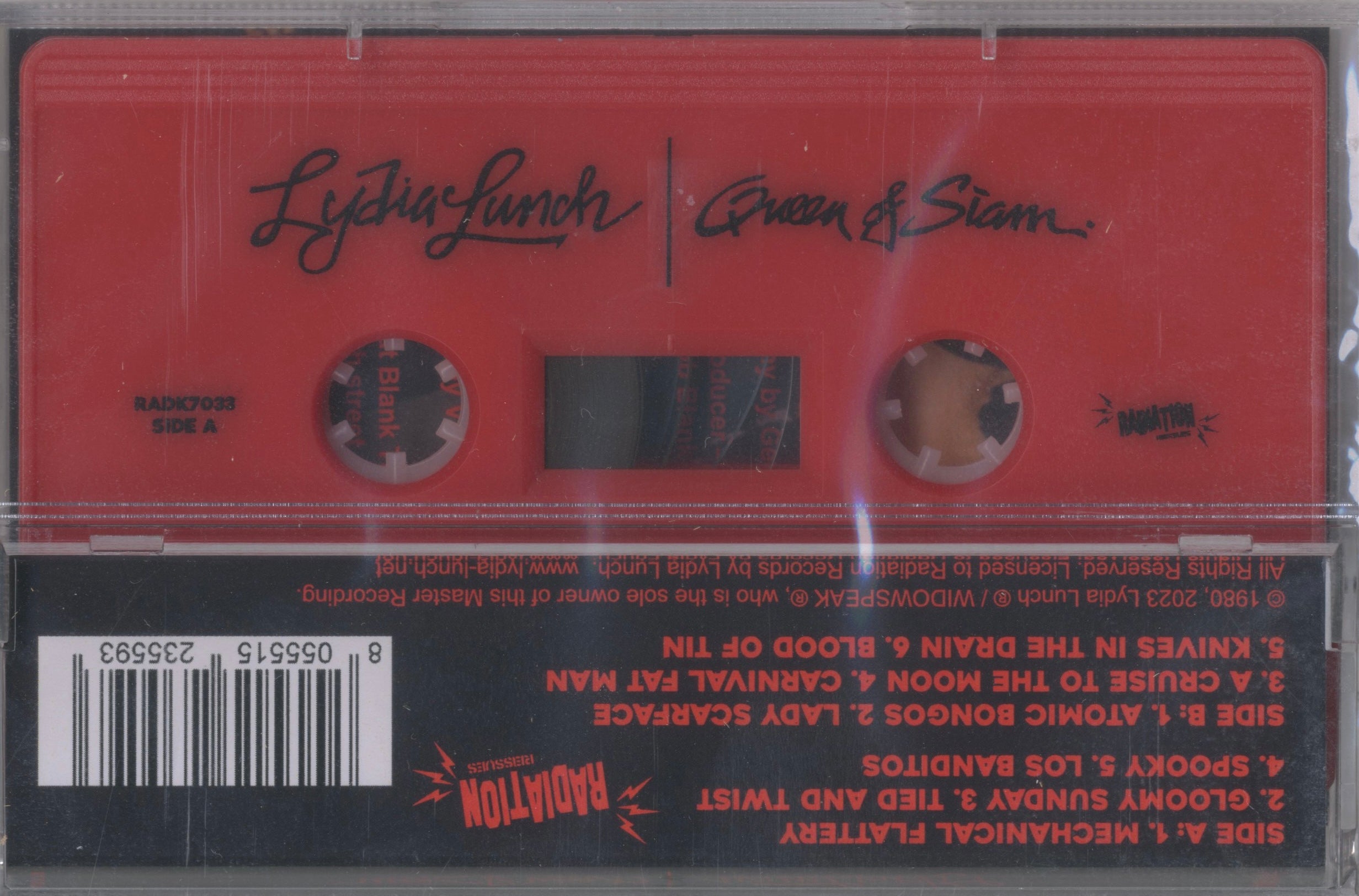 Red cassette shell of Lydia Lunch’s Queen of Siam — the 2023 Radiation Records reissue preserving the theatrical edge of her 1980 debut.