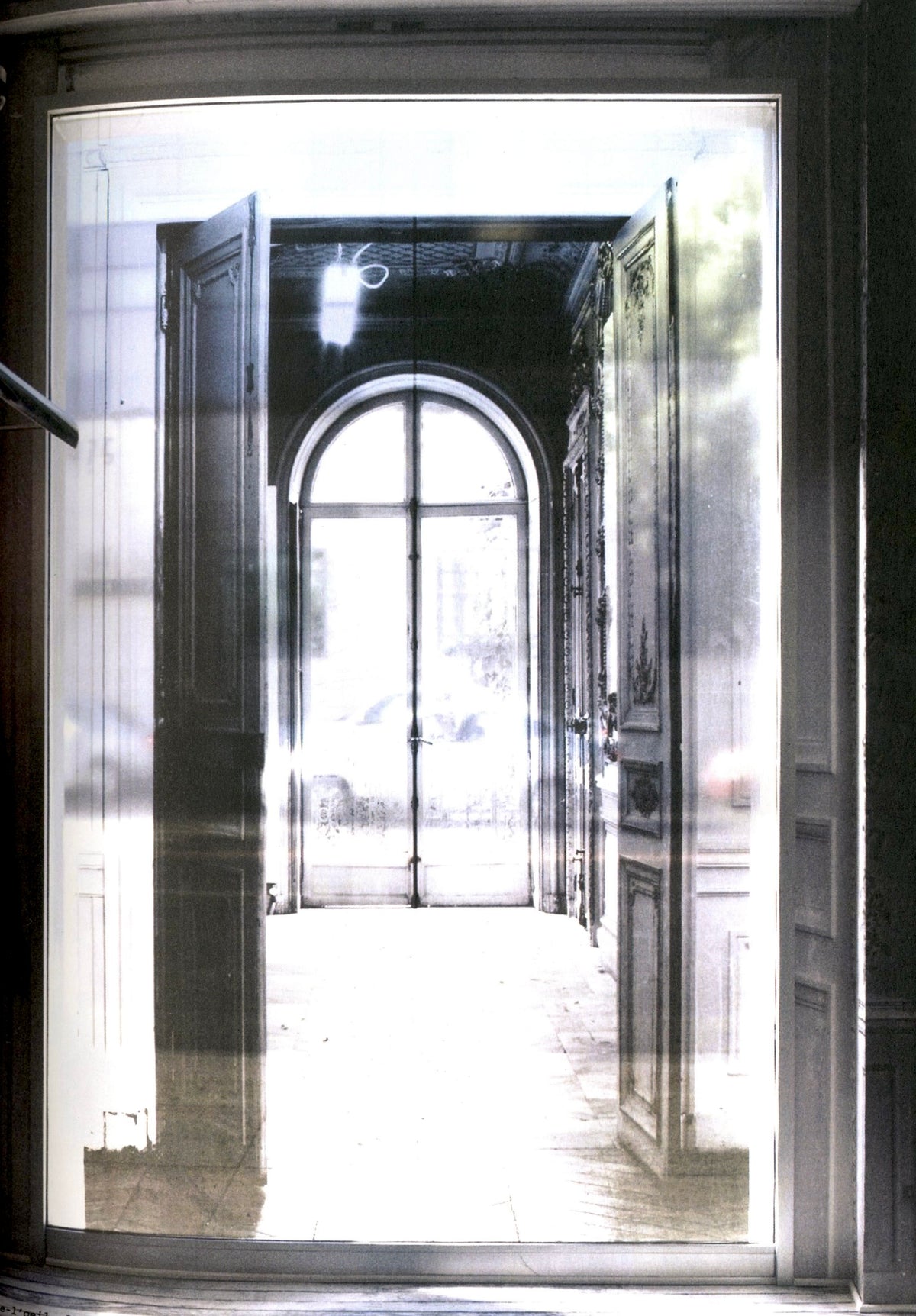 View through a tall doorway into a white room with an arched window, Maison Martin Margiela ‘20’ catalogue.