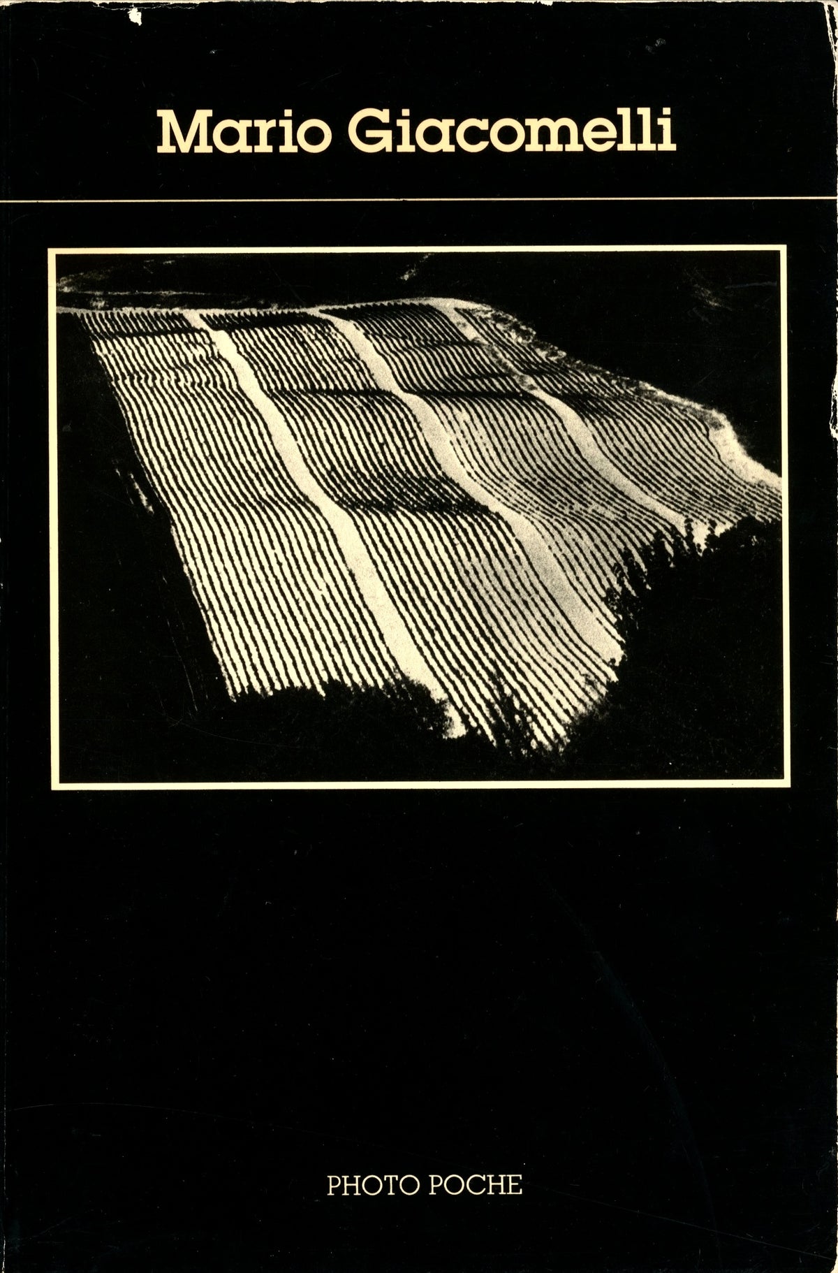 Mario Giacomelli Photo Poche No. 19 (1985), black cover with his aerial photograph of ploughed fields "Comme une page de journal".