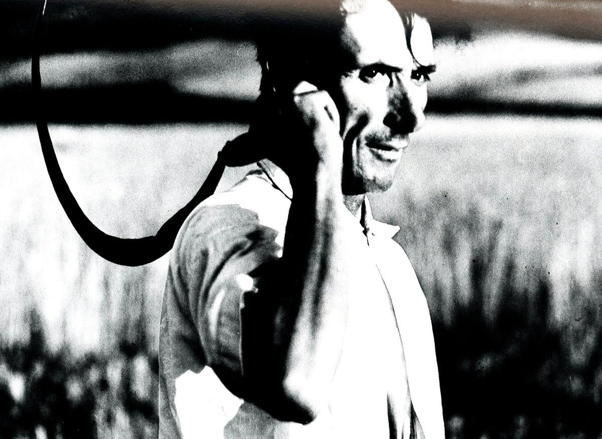 Giacomelli photograph from Photo Poche 19: a smiling farm worker in a field with a rope over his shoulder.