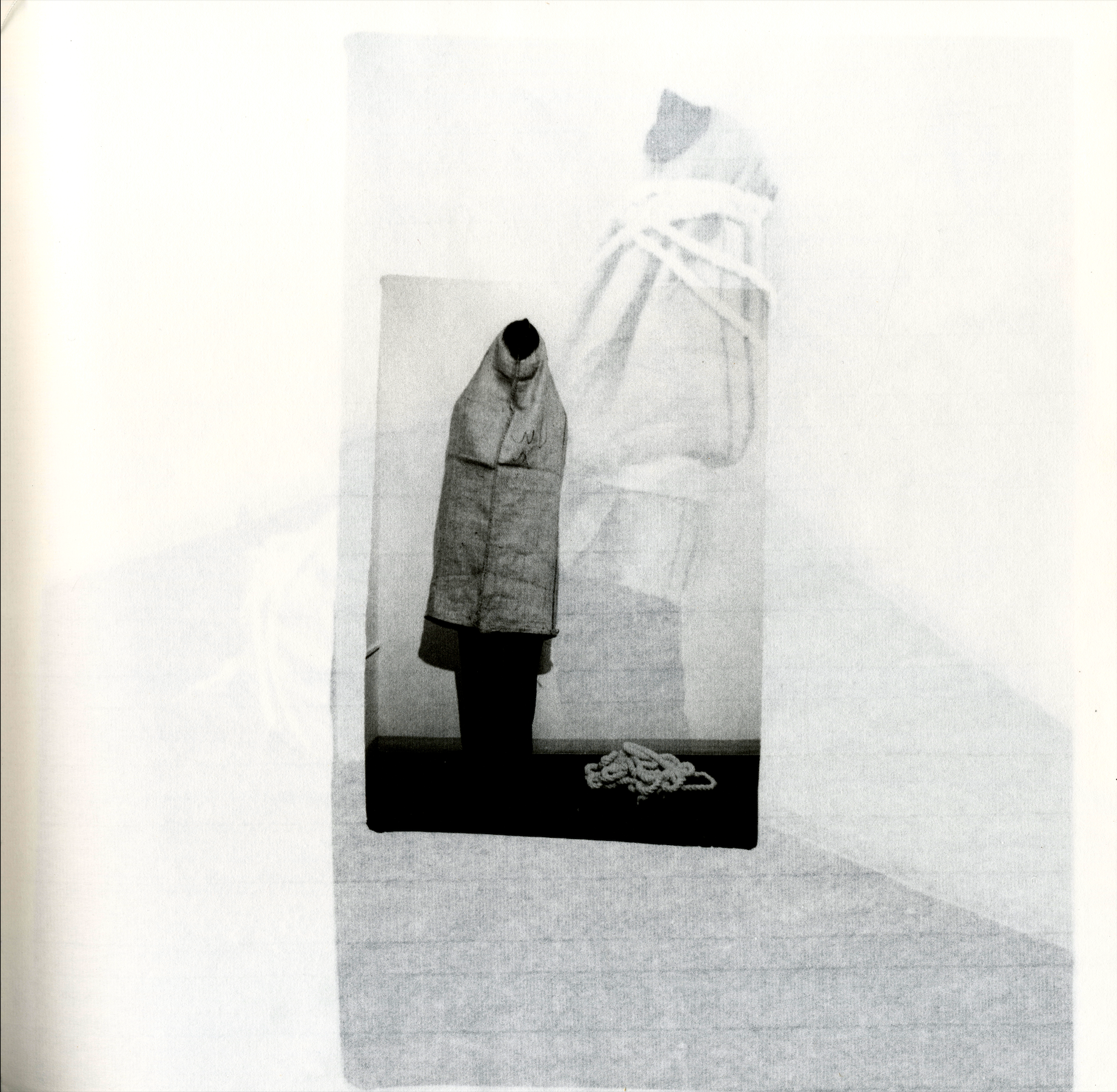 Performance documentation photograph from Guiones, featuring a figure in a minimal interior space.