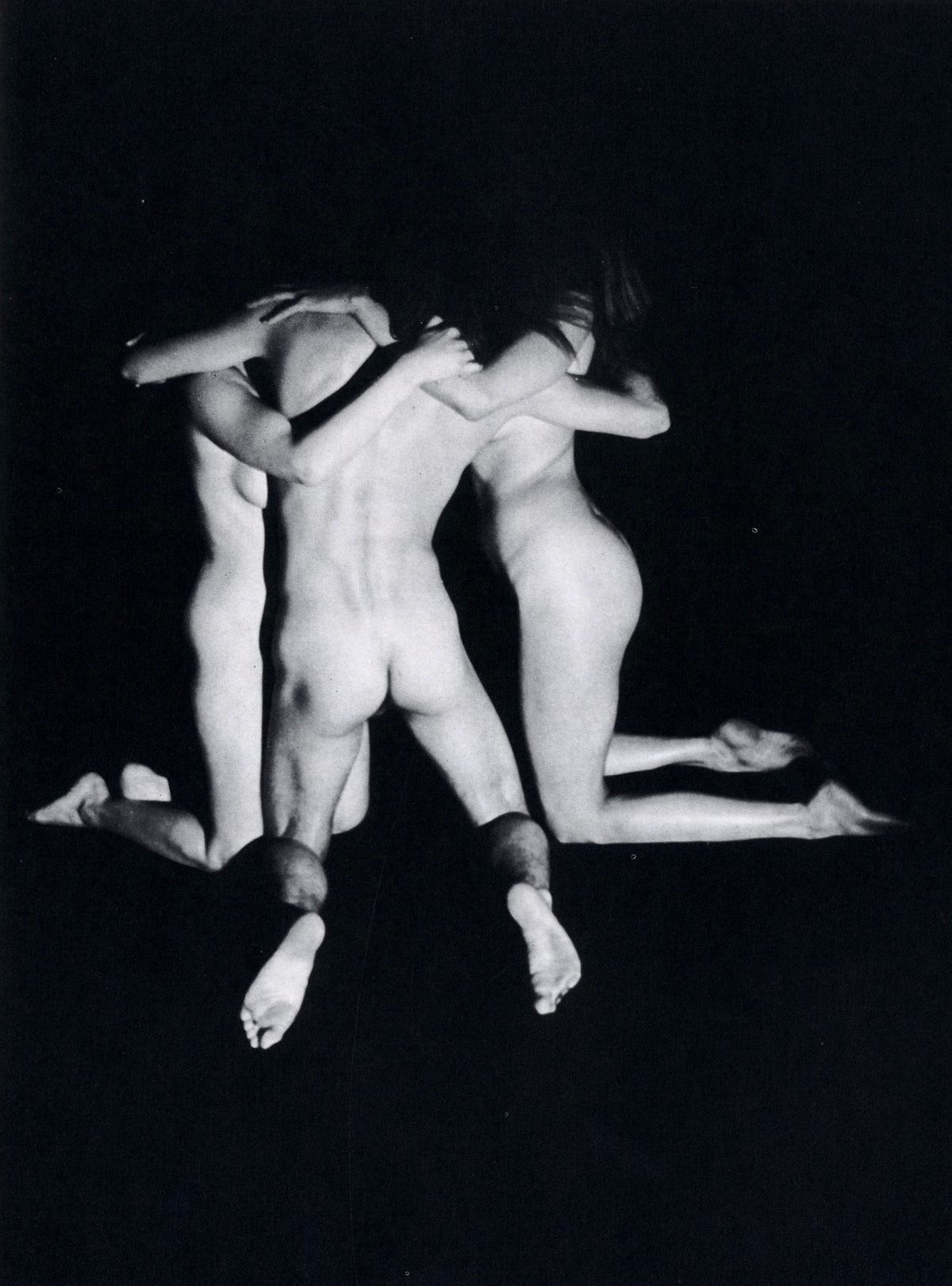 Group of standing female nudes in an embrace, seen from behind, black-and-white plate by Pierre Jousson.