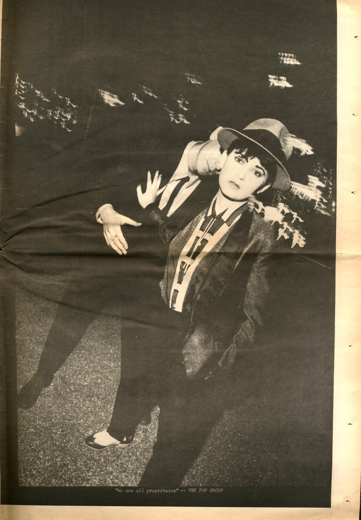 Page from RE/Search No. 1: figure in a hat and long coat posing with arms outstretched on a dark street.