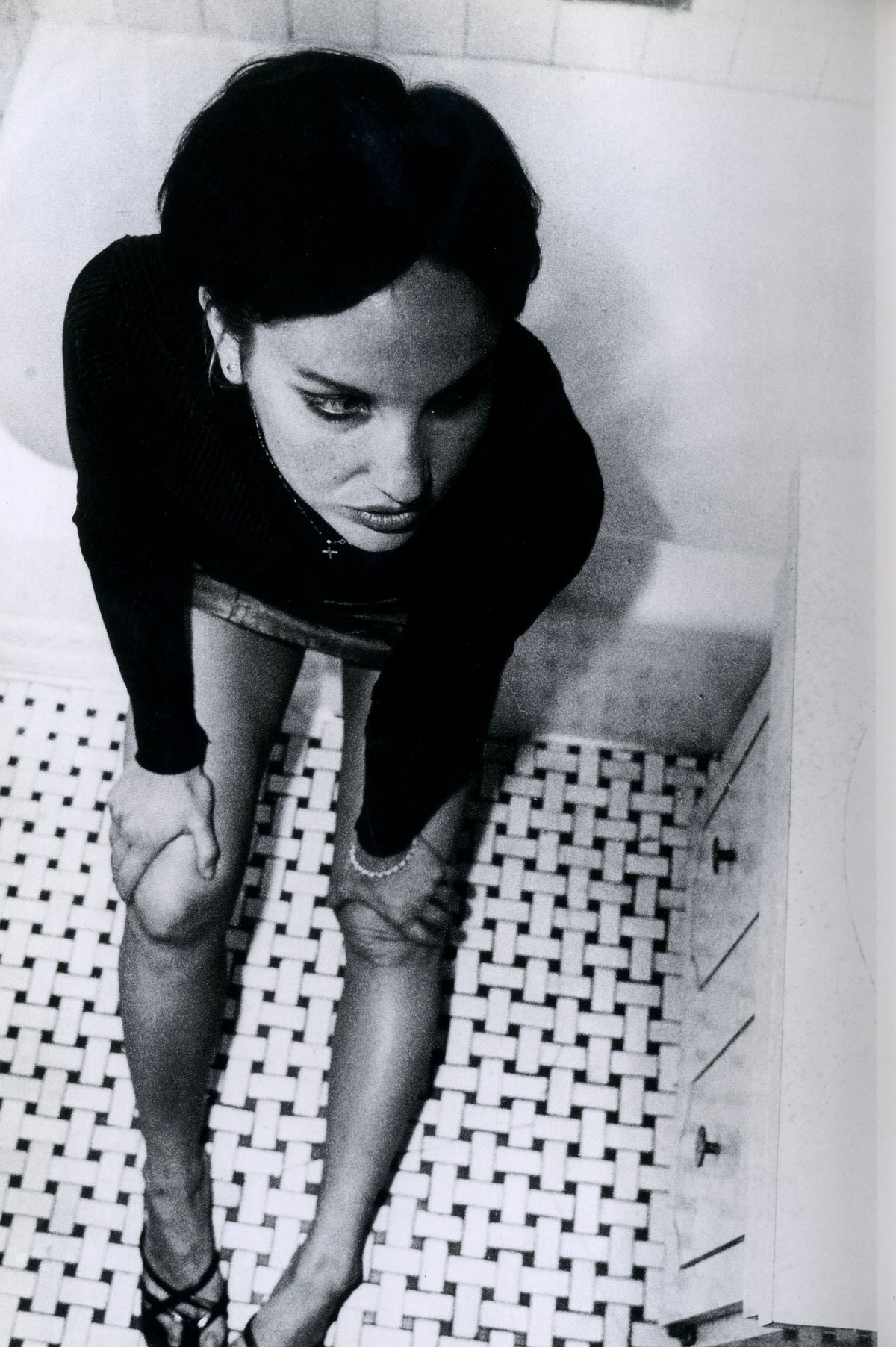 Black-and-white portrait of a young woman with a dark bob and lines drawn on her face, from XX Girls by Richard Kern.