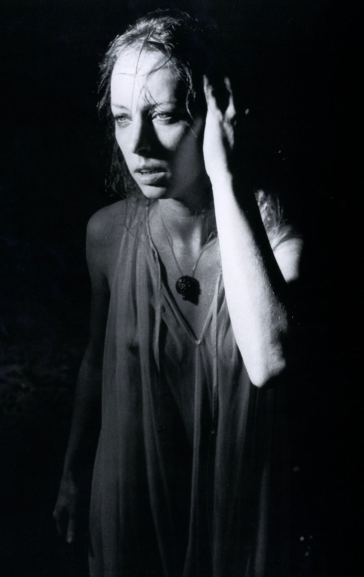 Blonde young woman with arms raised in a sheer blouse, black-and-white plate by Richard Kern.