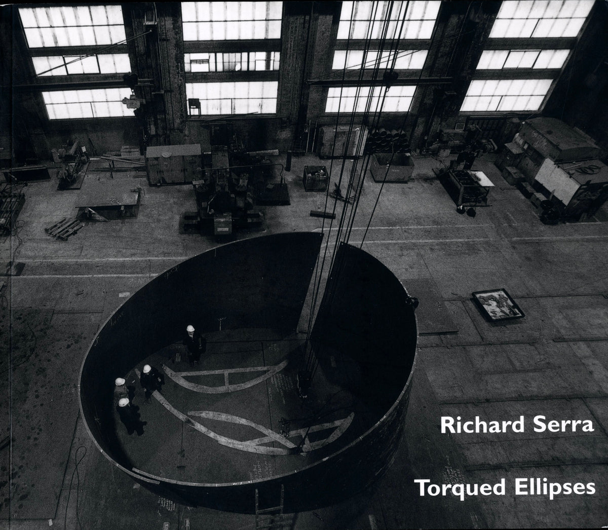 Richard Serra: Torqued Ellipses, Dia 1997, landscape cover: aerial view of a steel ellipse with workers inside a fabrication hall.