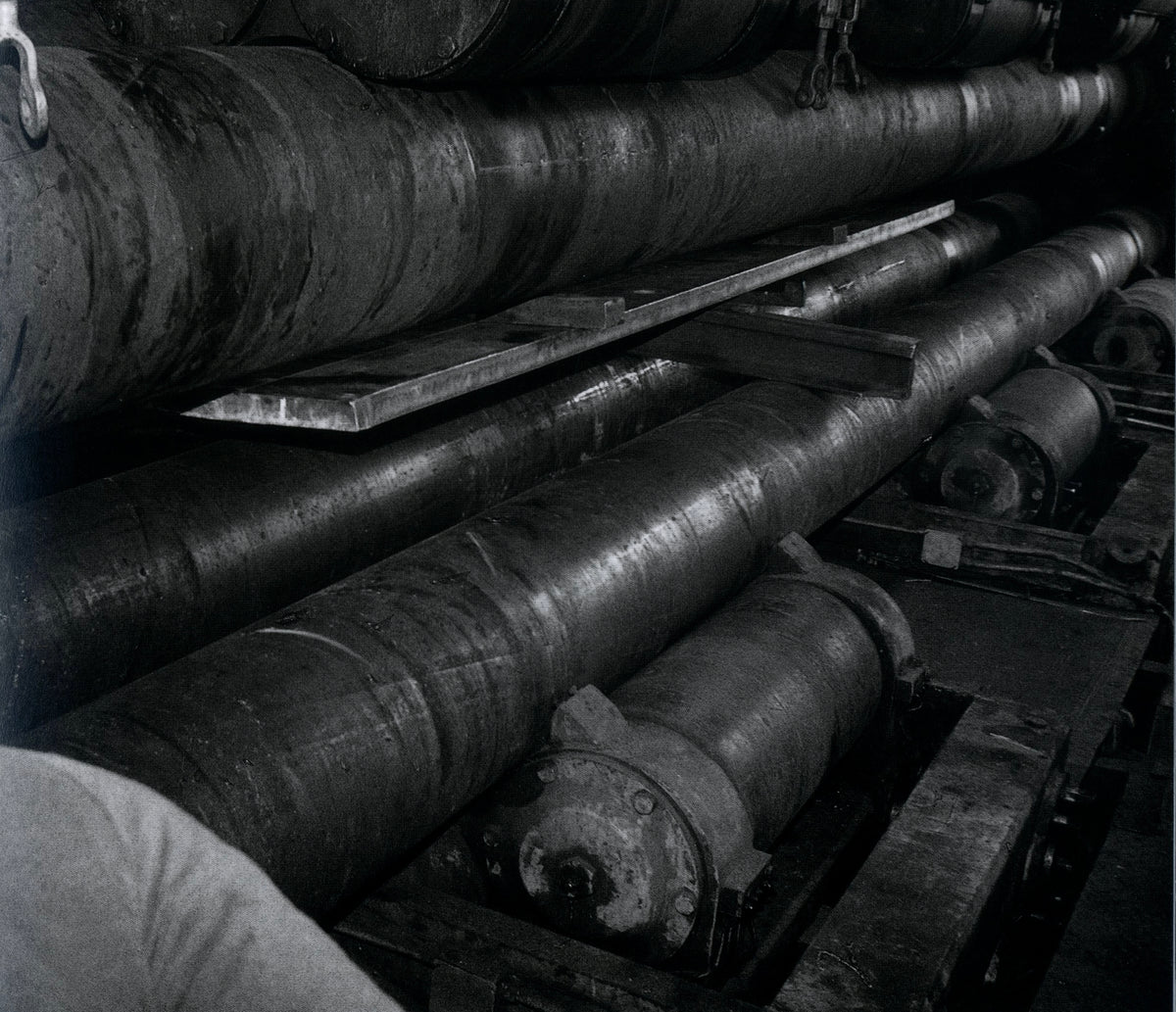 Massive rolled steel plates and rollers on the fabrication floor, Richard Serra: Torqued Ellipses.