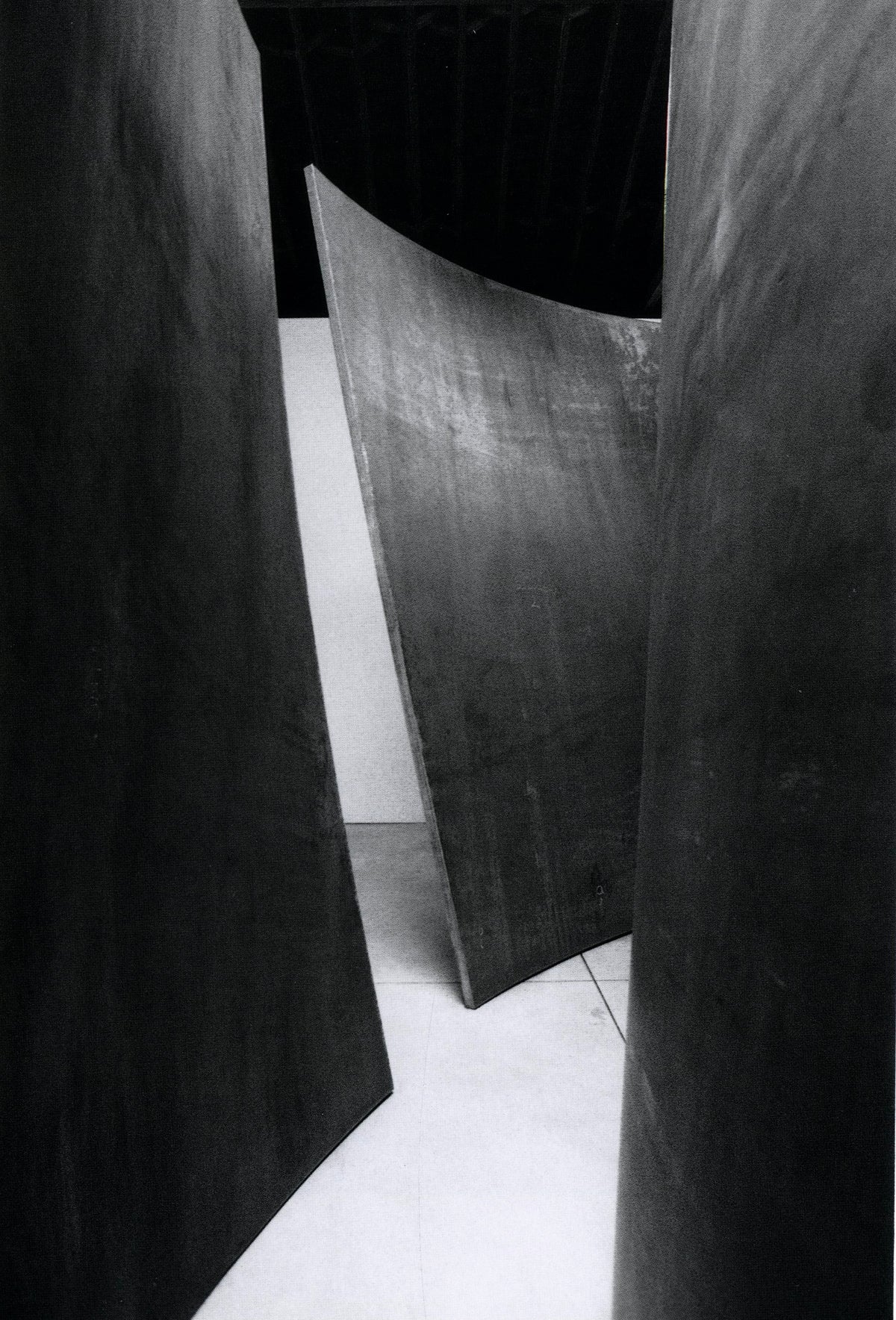 Curved weatherproof steel plate carried on a flatbed through a city street, Richard Serra: Torqued Ellipses.