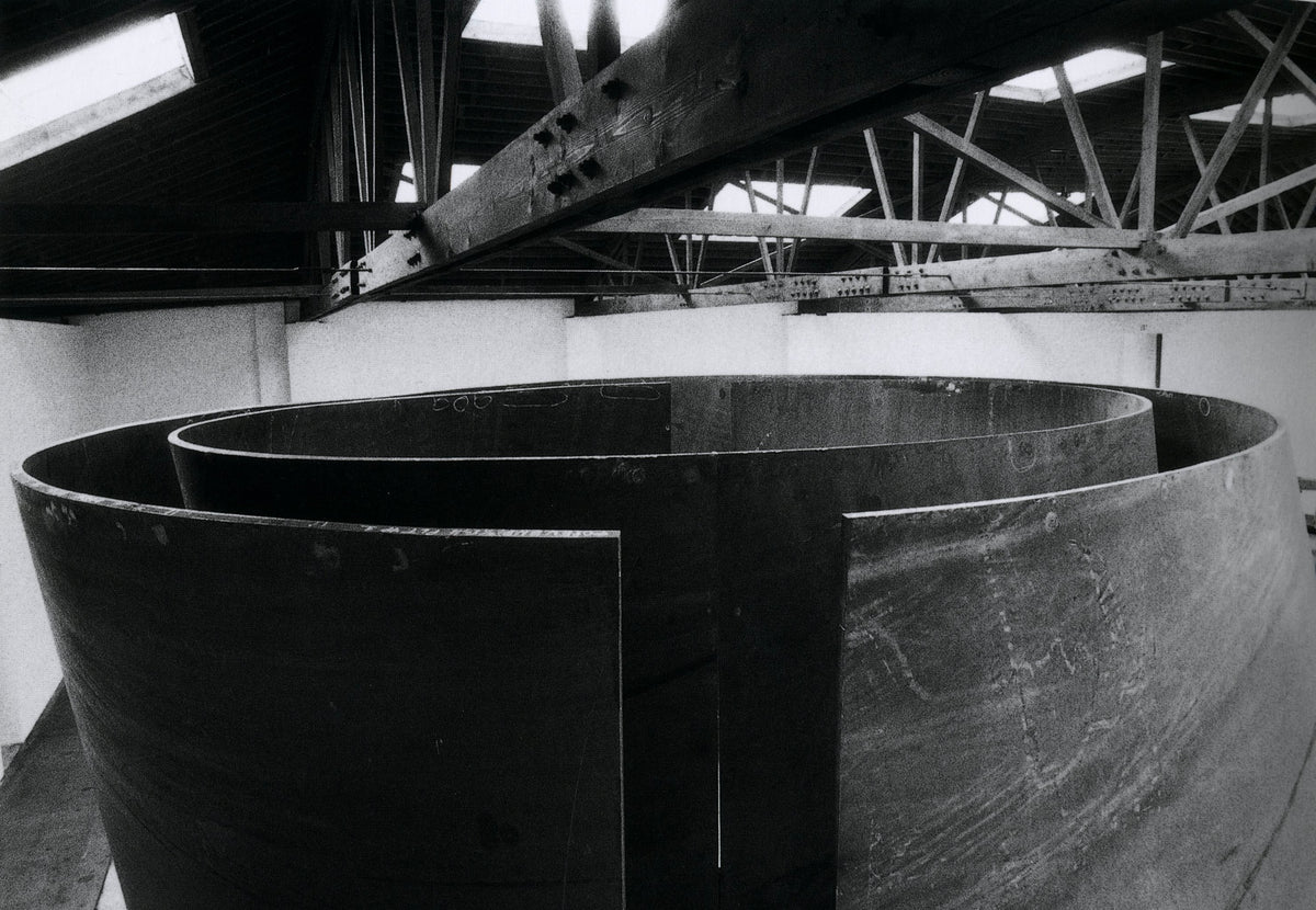 Curved weatherproof steel plate carried on a flatbed through a city street, Richard Serra: Torqued Ellipses.