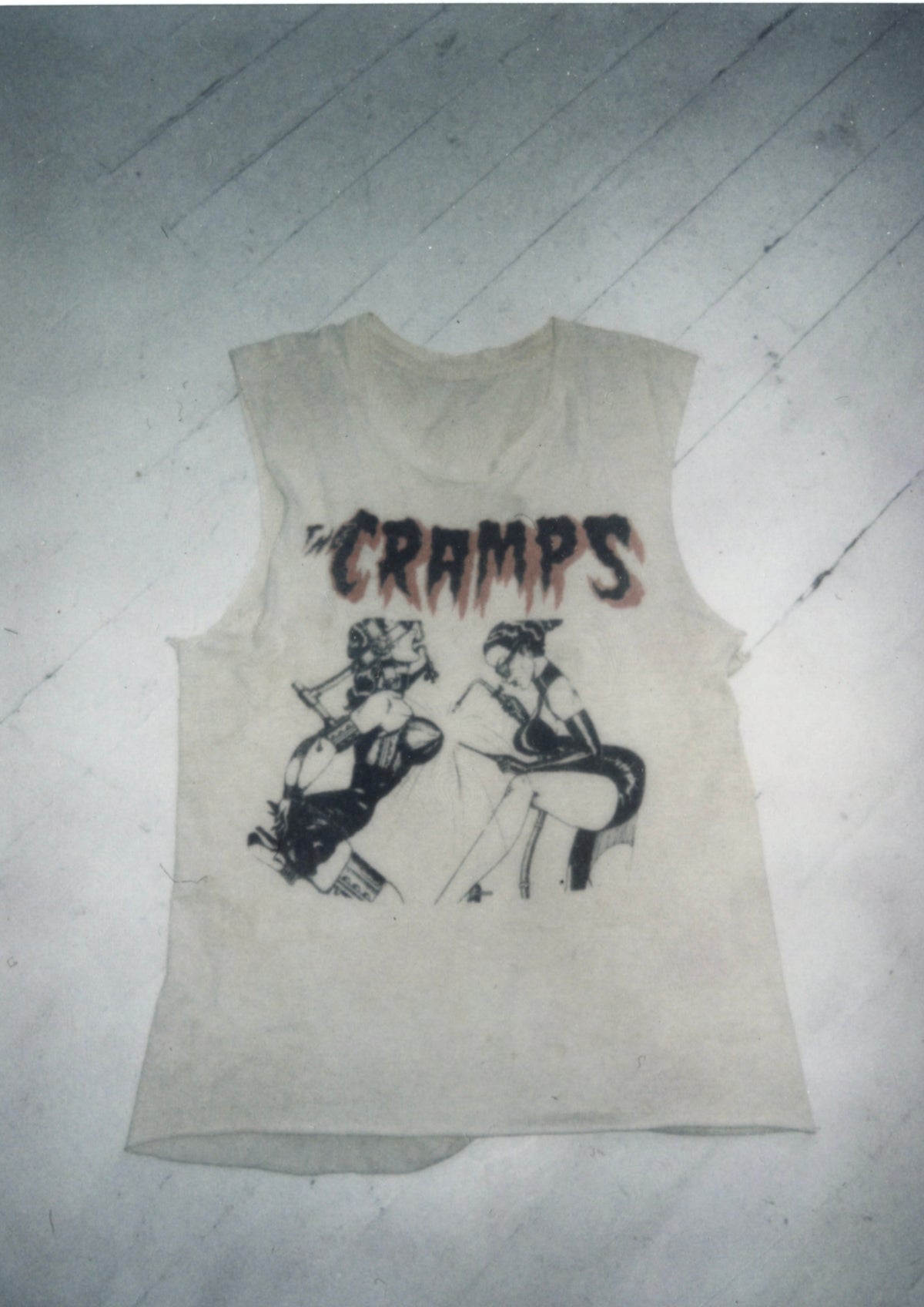 Vintage The Cramps sleeveless cut-off T-shirt with dripping red logo and illustrated figures, laid flat.