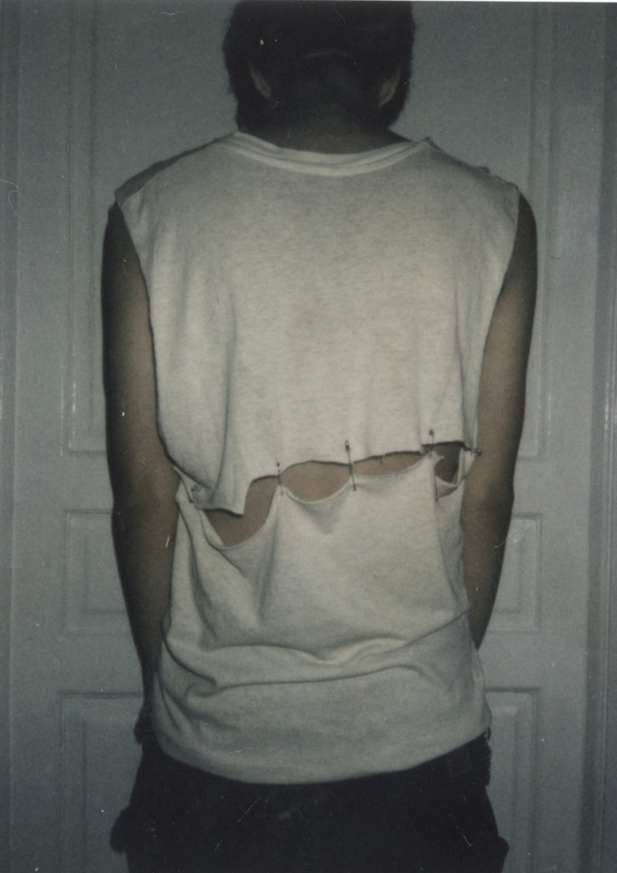 Back of the worn Cramps cut-off tee, split horizontally across the midpoint.