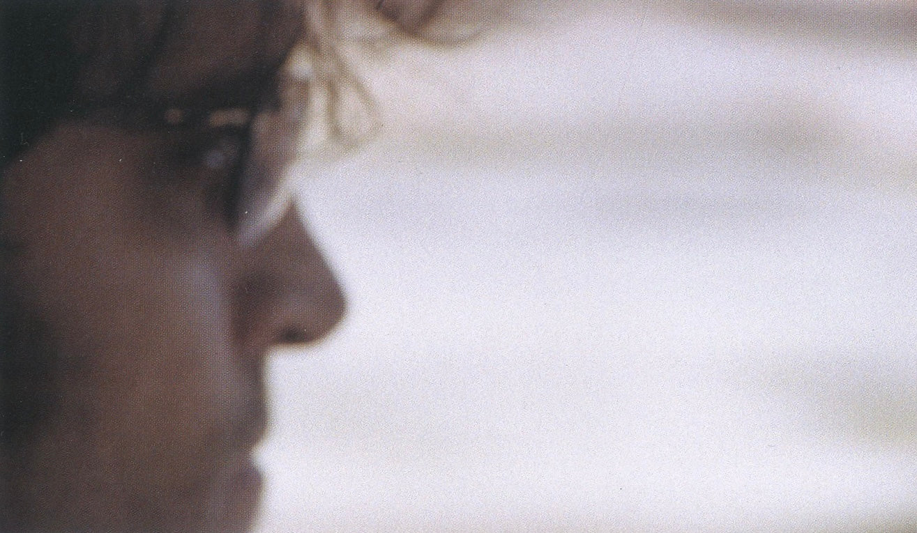 Interior still from The Brown Bunny featuring Vincent Gallo in a minimalist cinematic road movie composition.