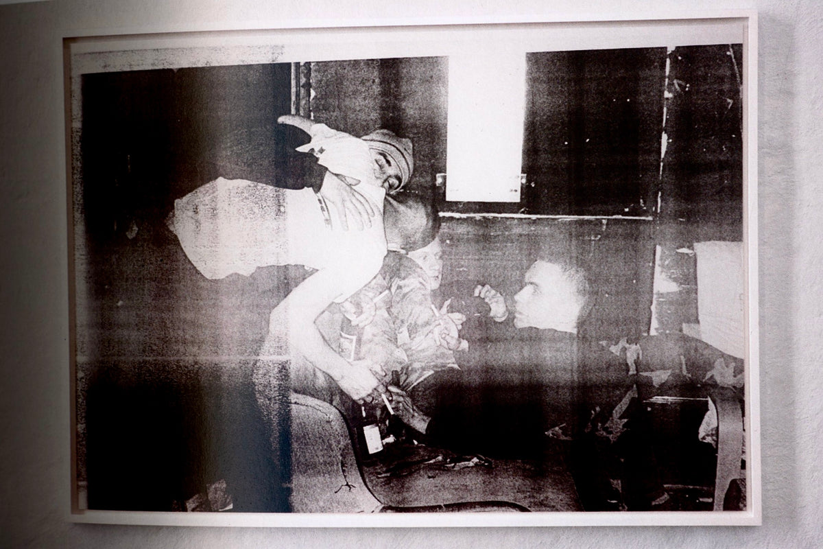 Gallery corner with photographs of varied sizes pinned in a loose wall arrangement, Wolfgang Tillmans: Lighter.