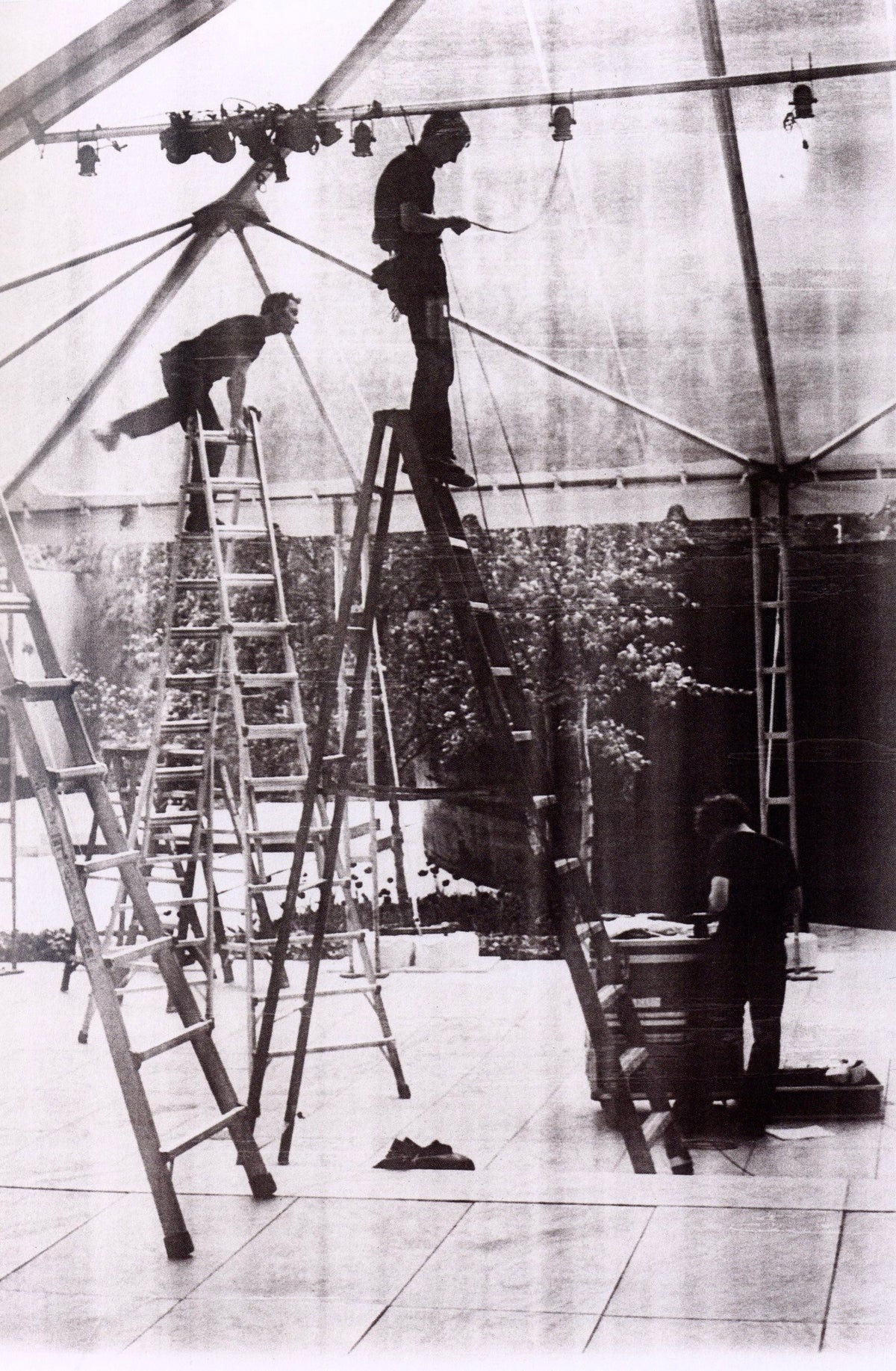 Grainy photocopy-based image of figures on a ladder beneath a scaffold structure, Wolfgang Tillmans: Lighter.