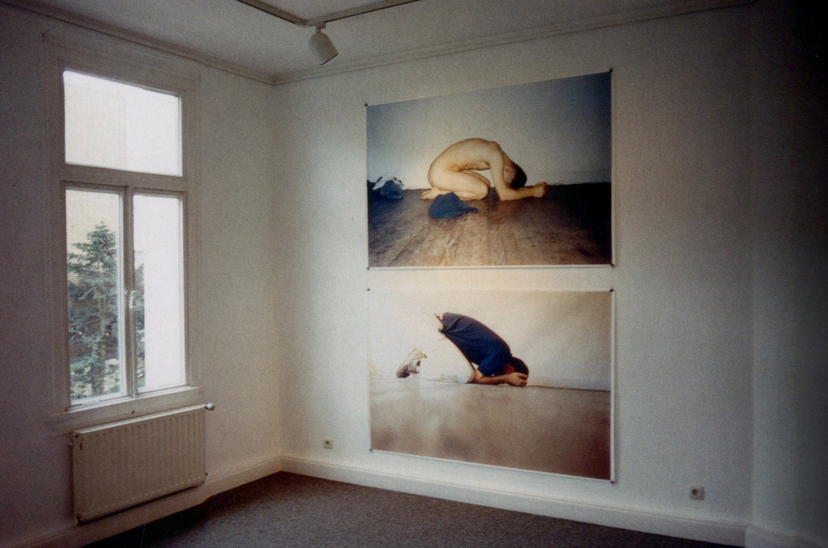 White gallery room with a row of small prints at eye level, installation view from Wolfgang Tillmans: Lighter.